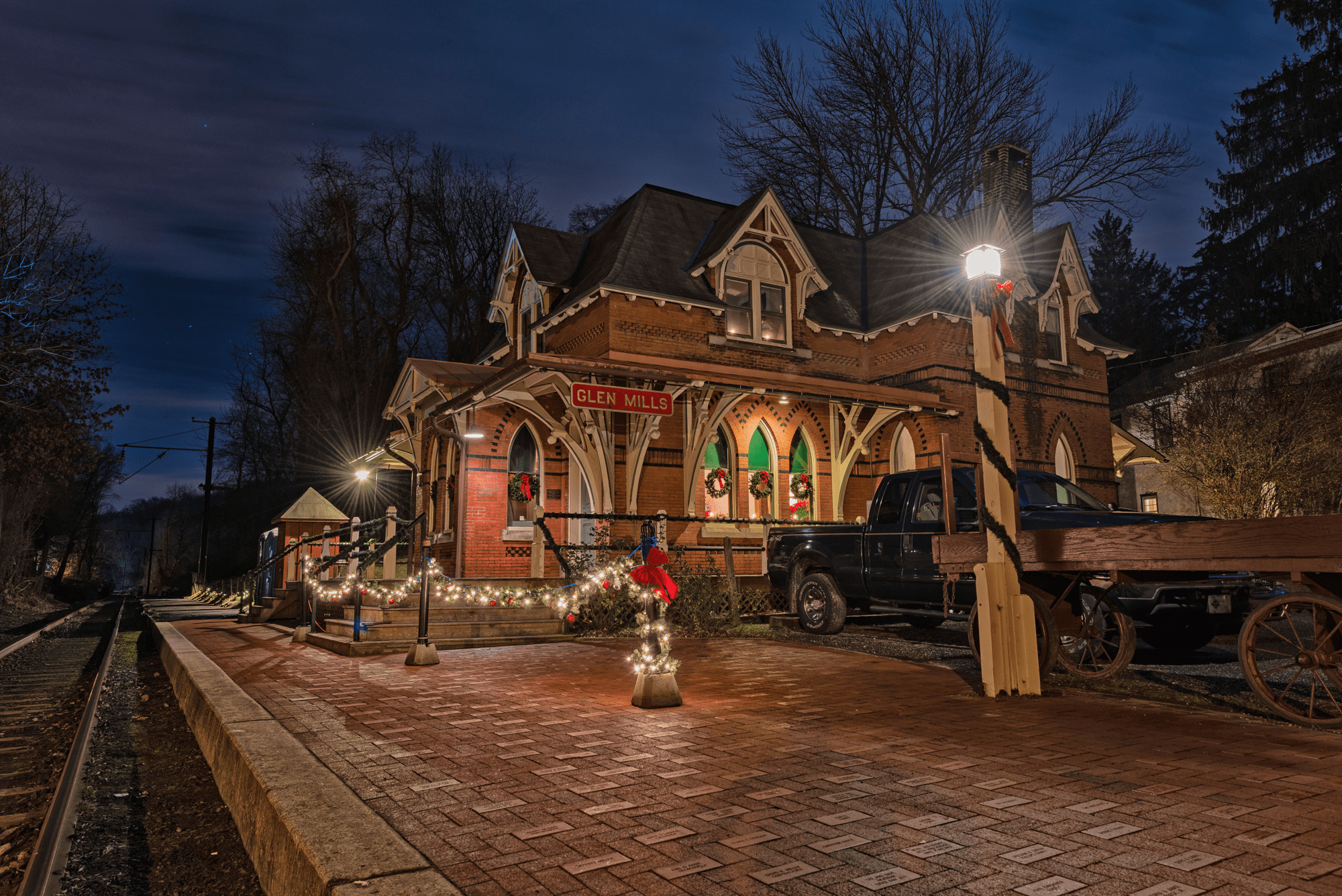Historic train station with Christmas lights at night.
